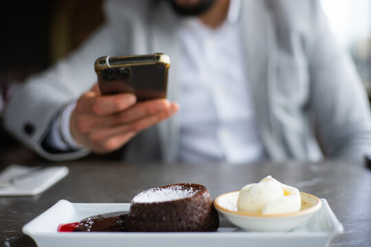 taking a photo of chocolate cake on a plate