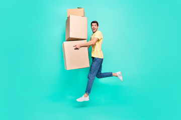 Full body profile photo of impressed brunet guy run with box wear t-shirt jeans shoes isolated on...