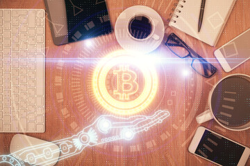 Double exposure of blockchain theme hologram over table with phone. Top view. Crypto technology...