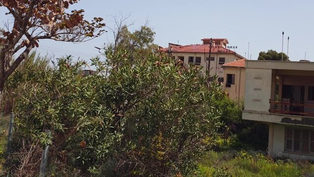 Wild vegetation in the yard of abandoned buildings in the Ghost Resort City of Varosha Famagusta, Cyprus
