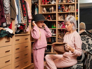 mother and daughter trying on hats