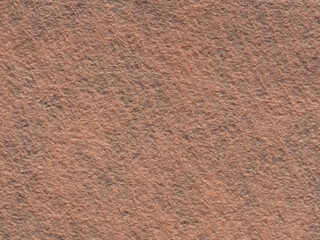 The texture of beige synthetic fabric felt material. Artificial felt cream color