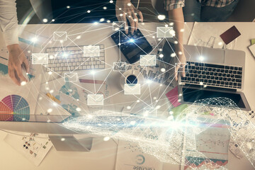 Double exposure of man and woman working together and envelop hologram drawing. e-mail concept....