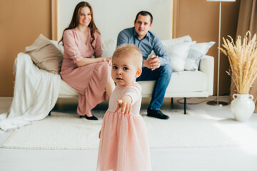 Mom and dad with a little daughter toddler in the studio.