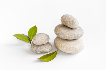 Spa massage stones with green leaves. Beauty treatment background