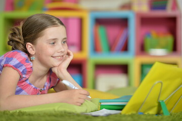 little cute girl doing homework  at home