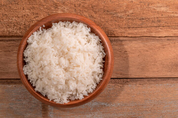 Rice white in bowl on wood table Asian healthy food.