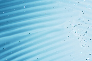 Close up macro Aloe vera gel cosmetic texture blue background with bubbles. Lemongrass gel skincare product. antibacterial liquid with aloe vera, moisturizing. Safe and environmental friendly.