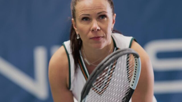 Potrait of Female Tennis Player Holding the Racquet During Championship Match, Ready for Receive Ball Strike. Professional Concentrated Woman Athlete. Sports on TV Channel. Focus on Face Slow Motion