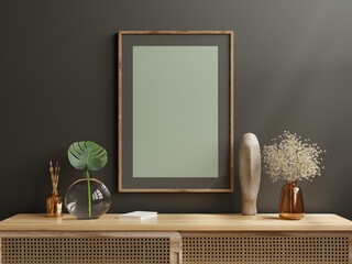 Dark photo frame on cabinet in living room interior on empty dark wall. © Vanitjan