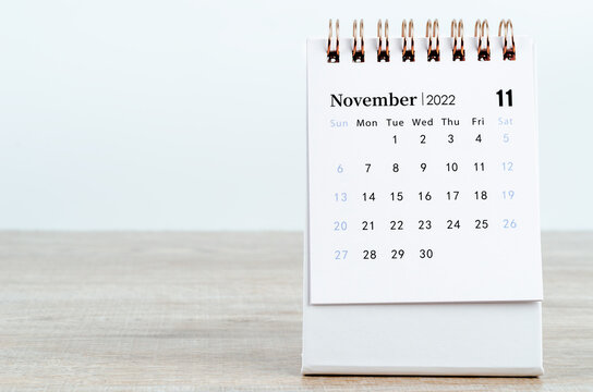 November 2022 desk calendar on wooden background.