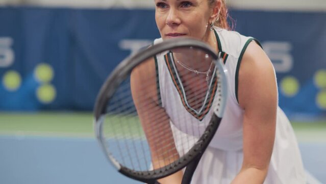 Potrait of Female Tennis Player Holding the Racquet During Championship Match, Ready for Receive Ball Strike. Confident Competitive Professional Woman Athlete. Sports Playback. Elevating Focus on Face