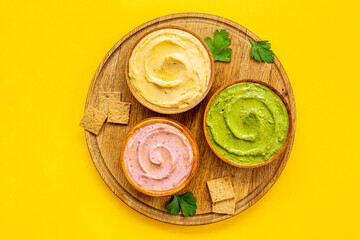 Various types of hummus with chickpeas spinach and beets. Flatlay top view