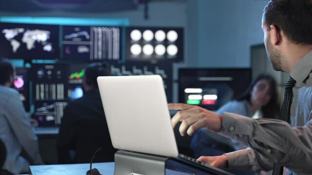 Stock Market Female Trader working together with coworker with laptop computer in the office 