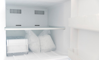 Fototapeta na wymiar closeup freezer with ice compartment packed inside.