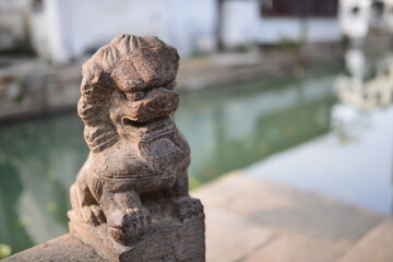 Fototapeta na wymiar Statue of a Stone Lion in Zhouzhuang Water Town, China