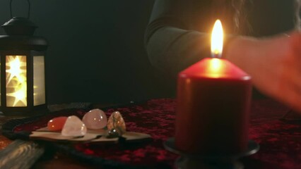 A tarot card divination session. Candle, stones and other paraphernalia