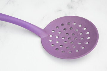 Close-up of a silicone Skimmer Slotted Spoon. Kitchen utensils.
