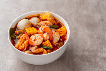 Shrimp soup bowl, Tom yum or tom yam is a type of hot and sour Thai soup, usually cooked with shrimp (prawn). Tom yum has its origin in Thailand.