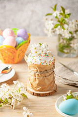Easter orthodox sweet cakes, kulich, cherry blossom flower and colorful eggs . Holidays Easter concept.