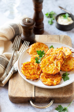 Hash browns or potato fritters on a plate with parsley