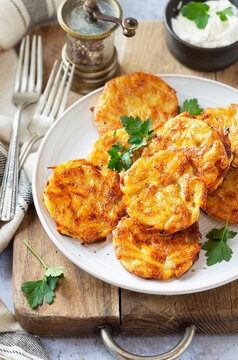 Hash browns or potato fritters on a plate with parsley