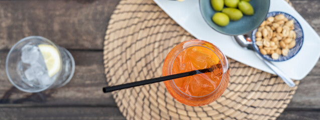 Horizontal banner or header with top view of spritz aperitif cocktail drink over bar club table -...
