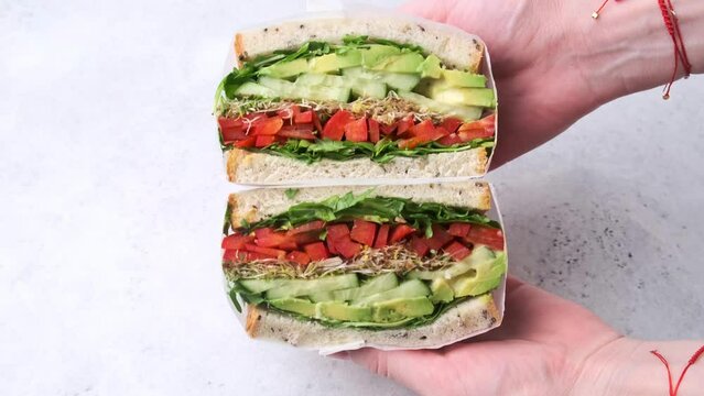 Vegetable sandwich in paper wrap. Vegan healthy food, takeaway food.