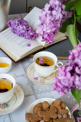 cup of tea with cookies and flowers