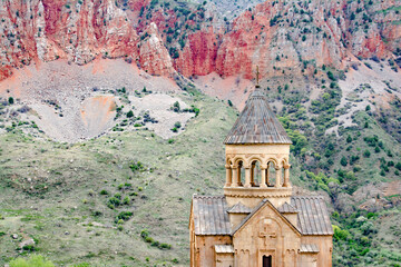 Fototapeta premium Church and red mountains. Monastery among beautiful mountains