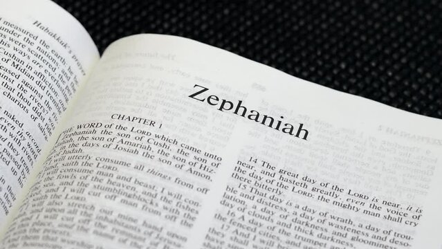 Close Up Shot of  Bible Page Turning to the book of Zephaniah