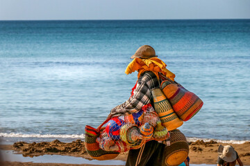 Beach vendors with colorful cheap bags