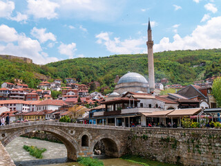 Old Ottoman bridge and mosque in Prizren, Kosovo on a sunny afternoon