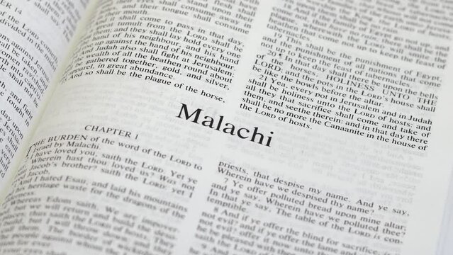 Close Up Shot of  Bible Page Turning to the book of Malachi