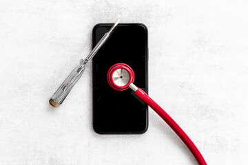 Obraz na płótnie Canvas Electronics repair servise concept - mobile phone with stethoscope
