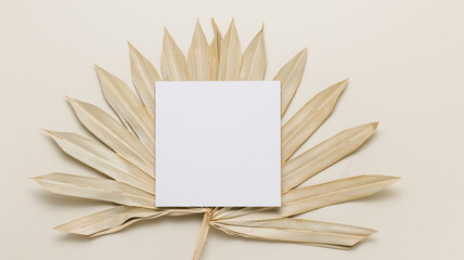 Invitation square card mockup on palm leaf top view, tropical vacation concept, boho style © Natureveryday