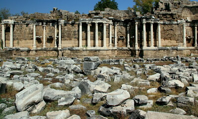 Fototapeta na wymiar Ruins of the ancient Roman fountain Nymphaeum with snow-white columns in the historic part of Side, near Antalya, Turkey