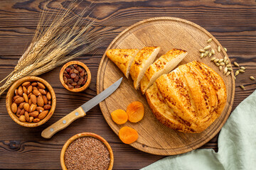 Bread with dried fruits and nuts. Healthy home baked loaf top view