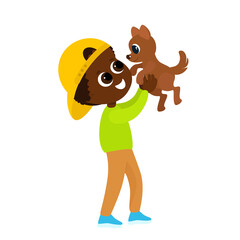 The boy plays with the dog and holds it in his arms. A child in a baseball cap and trousers and a sweater. Friendship between man and dog. The child is happy and cheerful.