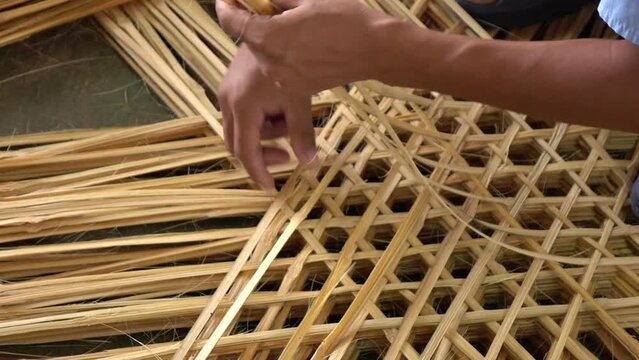 Close up hand weaving basket from bamboo
