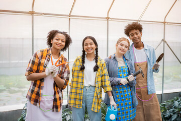 Portrait of teenage girl and boy playing in the vegetable garden.