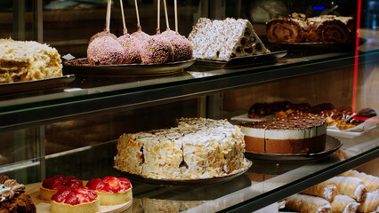 Concept of food and restaurant in the coffee bar taking video of a fresh and tasty deserts from the showcase fridge