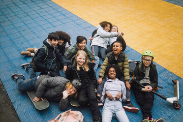 High angle view of diverse school students relaxing in sports court
