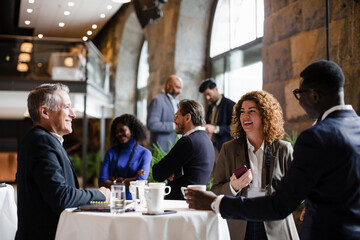 Happy business delegates in meeting at conference center