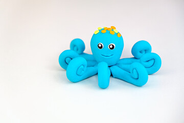 blue plasticine octopus on white background, children's games with modeling clay