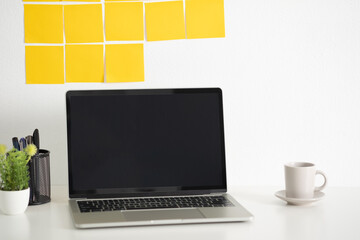 Yellow post note paper, memo paper on a screen laptop computer. scheduled for job or short note for work concept, minimal office desk