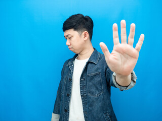 Man jean shirt show hand stop turn away face serious emotion blue background
