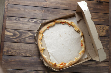 empty pizza box on wooden. Leftover pizza in a box.