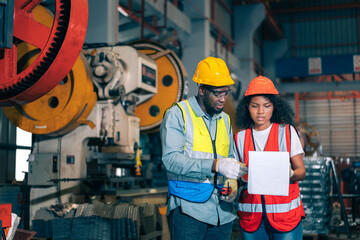 Two professional engineer/worker/technician use clipboard discuss work, walk in steel metal...
