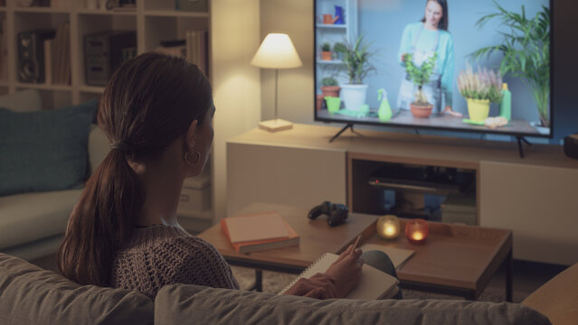 Woman watching a TV show about gardening